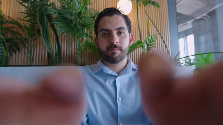 Cinemagraph loop of a man looking directly at the camera from a first-person perspective during a video call