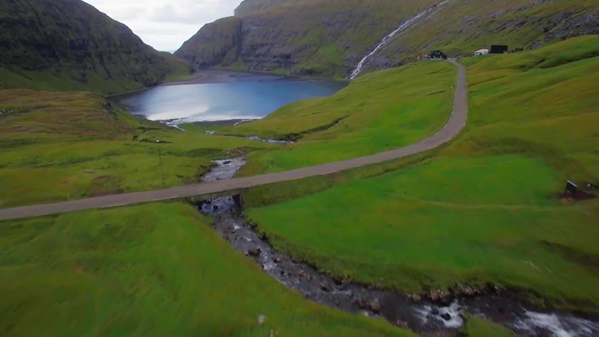 Sod houses near a lake in the mountains