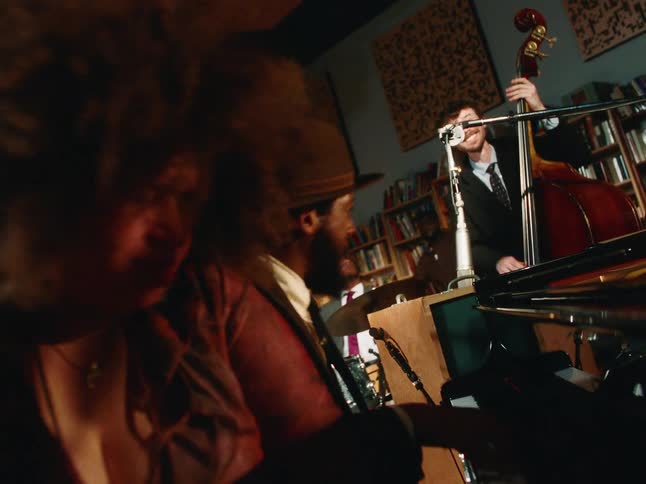 A passionate jazz quartet performs an energetic set in a cozy, book-lined studio