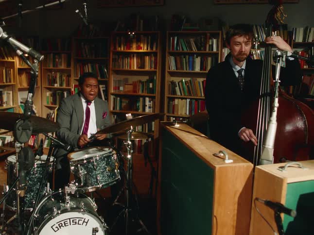 A diverse jazz quartet performs a soulful set in an intimate library setting, surrounded by bookshelves