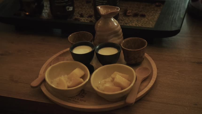 A beautifully arranged tray of mango sticky rice and a warm beverage served at a tranquil spa