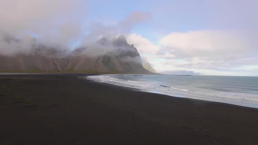 Waves flow onto the sand on the shoreline