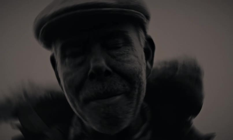 A dramatic black and white close-up shows an older man looking up as his eyes roll back into his head, suggesting a supernatural or possessed state