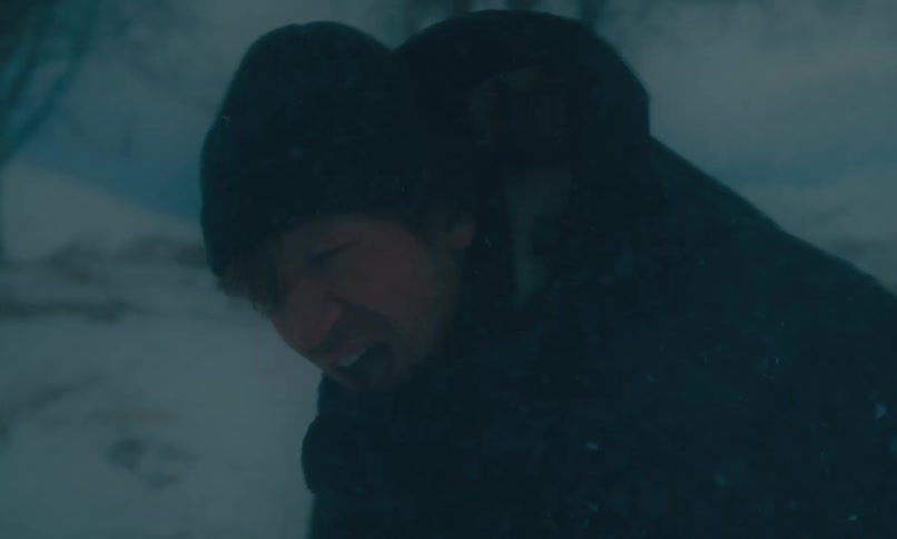 A desperate man cries out in pain as he struggles through a fierce blizzard in a desolate winter landscape