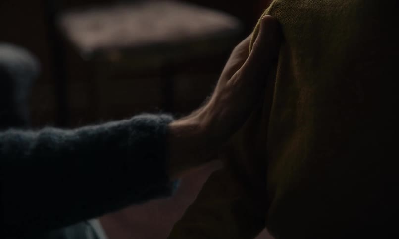 A close-up of a parent's hand gently holding a child's hand, offering comfort and reassurance through a tender touch