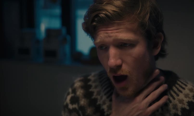 A close-up of a young man's face as he receives devastating news, showing shock, disbelief, and overwhelming sorrow