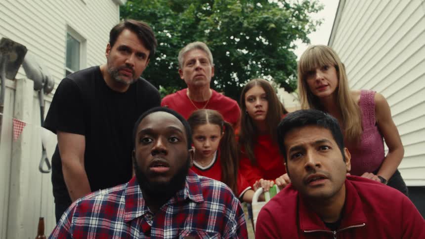 A diverse group of sports fans gathered in a backyard go through a rollercoaster of emotions from shock and anger to triumphant celebration