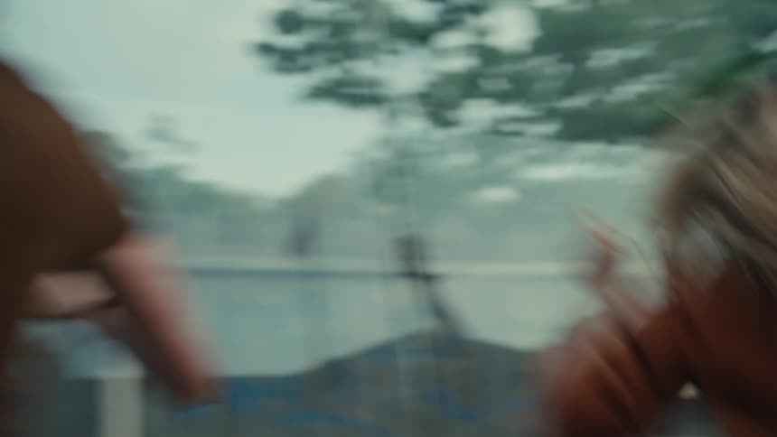 Friends react with shock and then explode into joyful celebration while watching a thrilling event on a smartphone in slow motion
