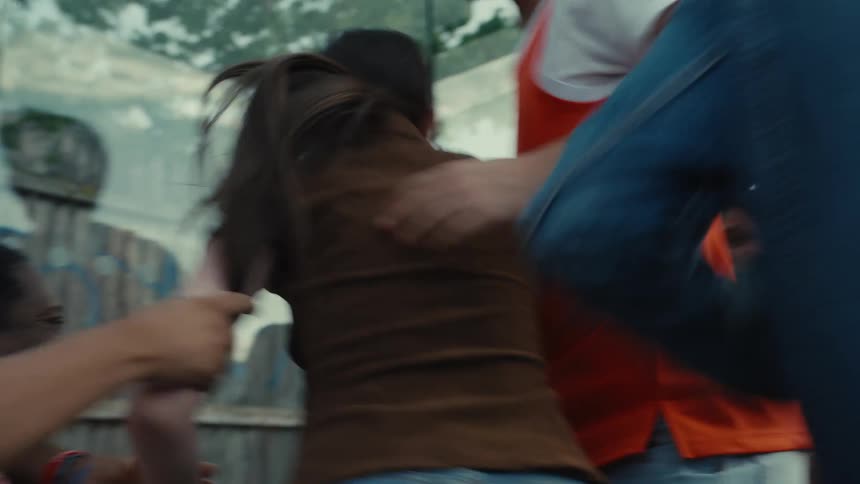 Diverse friends watch a game on a smartphone, erupting in a joyous and chaotic celebration at a bus stop in slow motion