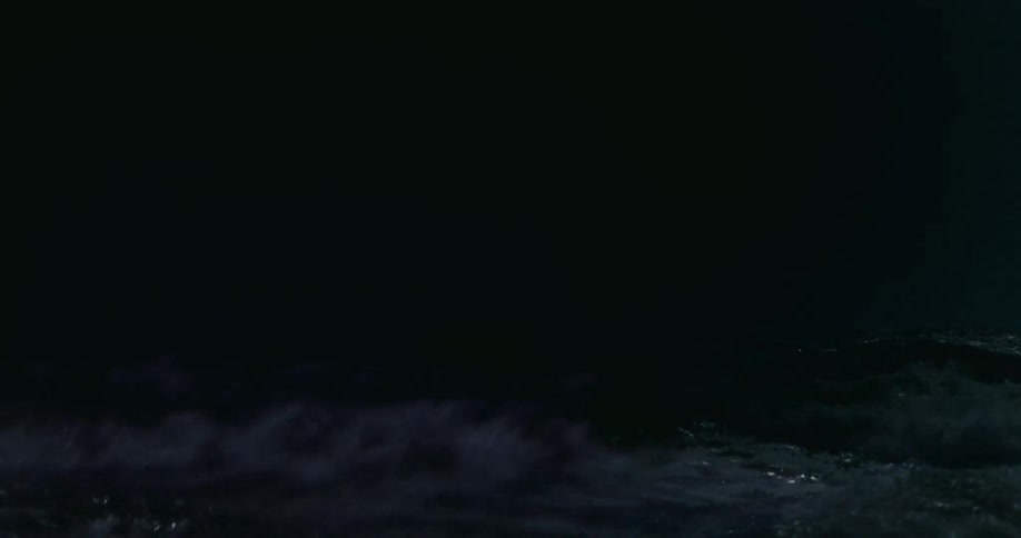 A lone ship battles the violent waves of a dark and stormy sea at night