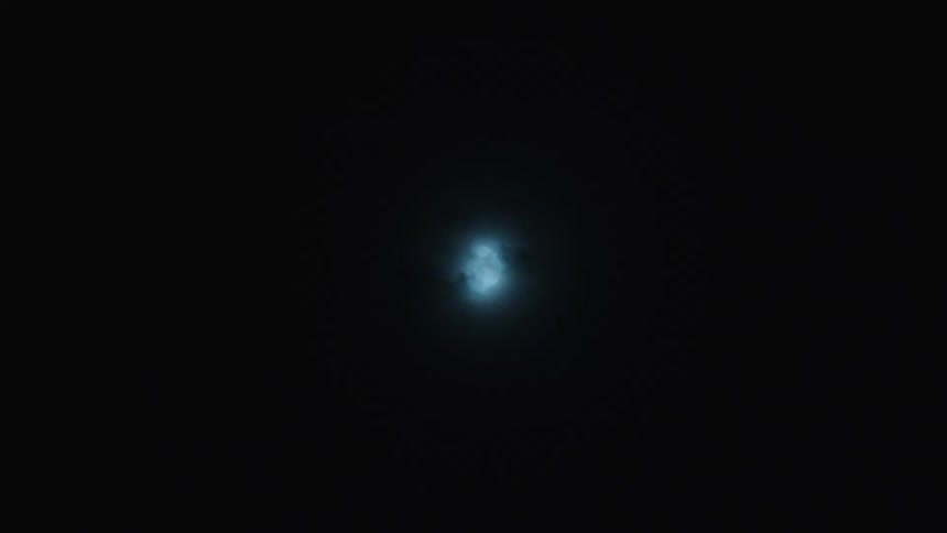 A mysterious moon glows brightly as dark clouds pass by in a night time-lapse