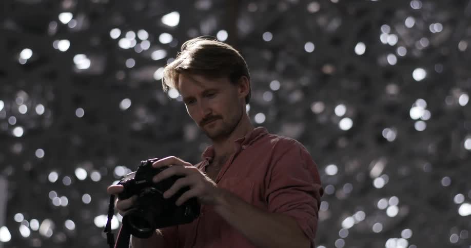 A photographer holds a camera