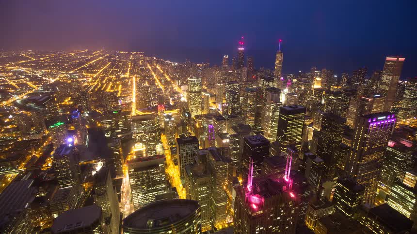 A high-angle time-lapse captures the vibrant energy and glowing lights of downtown Chicago at dusk