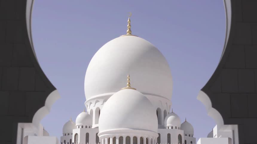 People stand in front of a domed building