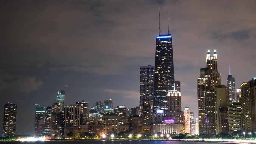A stunning night timelapse of the Chicago skyline featuring the iconic John Hancock Center as clouds and traffic quickly move past