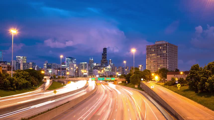 Day to night timelapse of traffic on the Eisenhower Expressway leading into the Chicago skyline