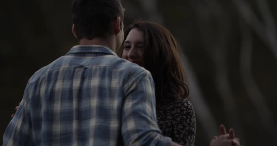 A man and woman dance outside