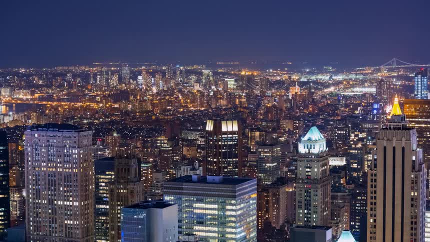 A captivating night timelapse of the New York City skyline with its towering skyscrapers and endless city lights