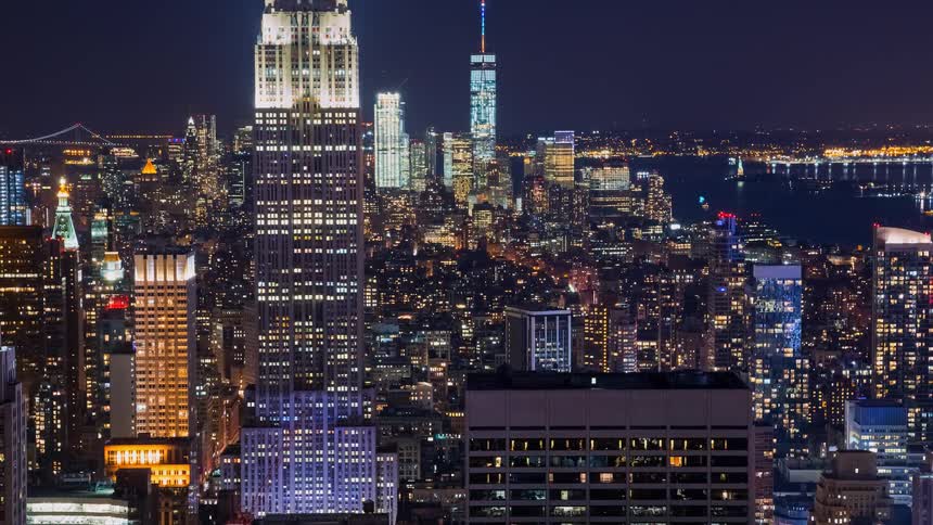 A stunning night timelapse of the iconic New York City skyline, featuring the Empire State Building and One World Trade Center