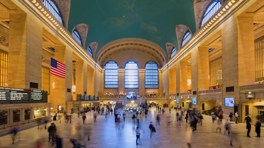 A bustling time-lapse of commuters and tourists moving through the grand main concourse of Grand Central Terminal in New York City