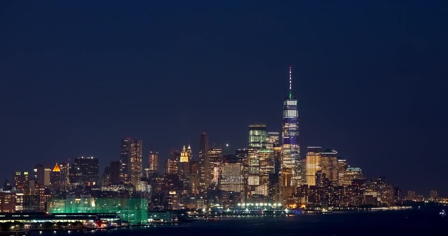 A stunning time-lapse of the iconic Lower Manhattan skyline at night, with the One World Trade Center brilliantly illuminated
