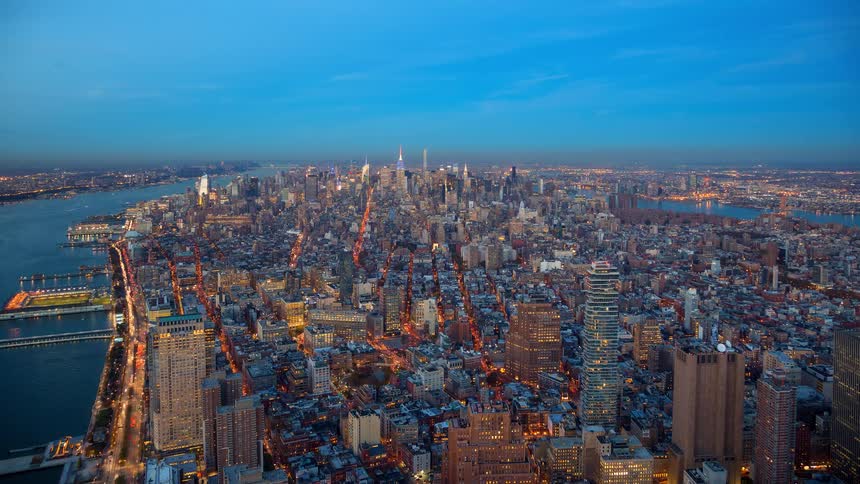 Stunning day-to-night timelapse of the New York City skyline, showcasing the transition from a beautiful sunset to the vibrant, illuminated cityscape of Manhattan