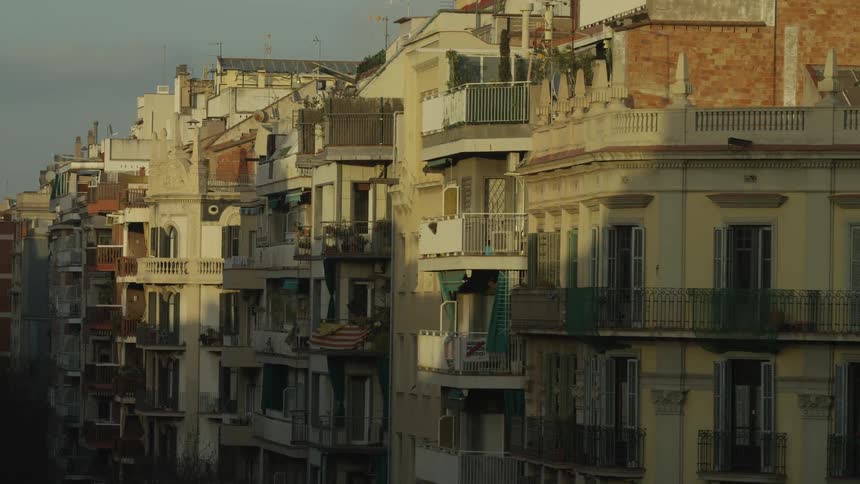 A timelapse of the morning sun casting moving shadows across the ornate facades of apartment buildings in a European city