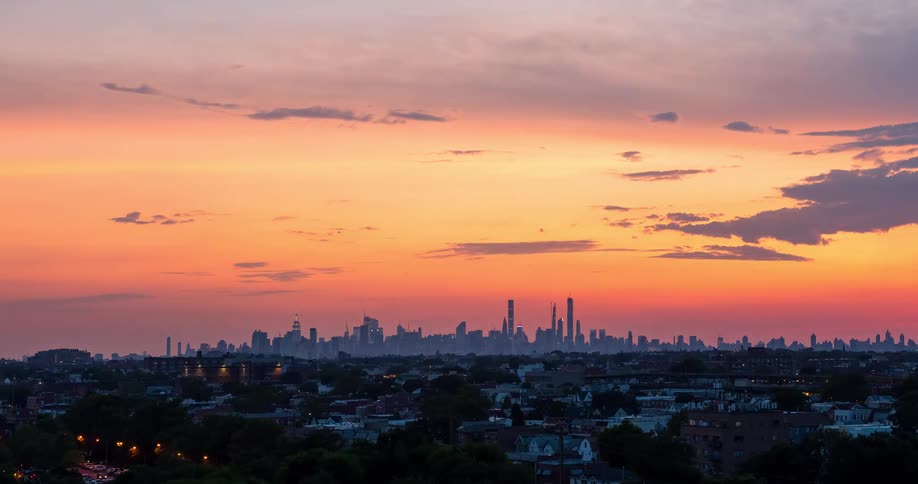 A brilliant sunset transitions to night over the New York City skyline in this stunning day-to-night timelapse