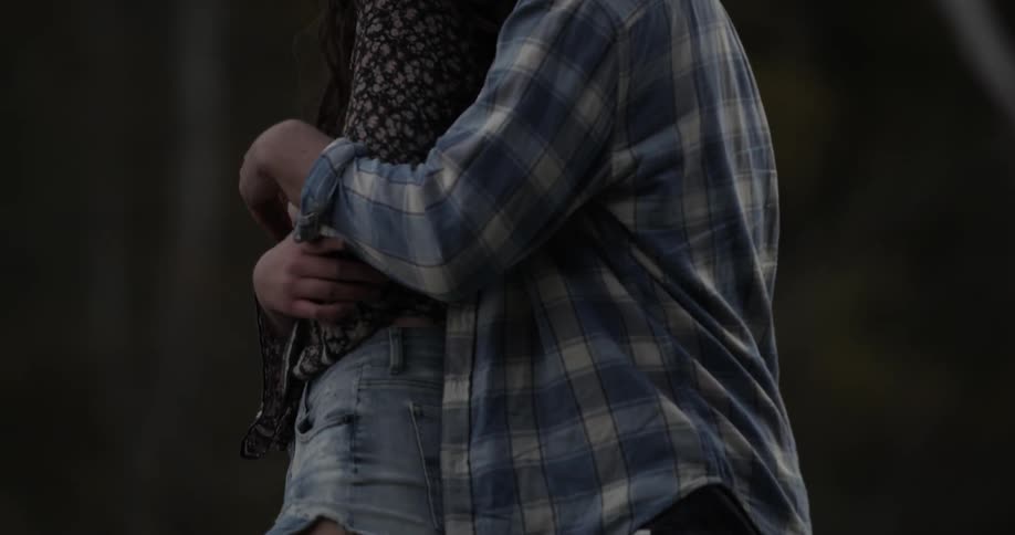 A man and woman hug and rock back and forth