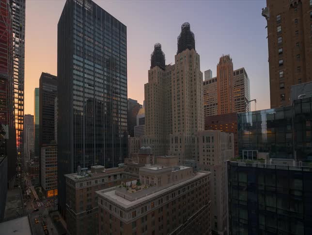Sunset to night timelapse of iconic architecture in Midtown Manhattan, as the city lights illuminate the skyline