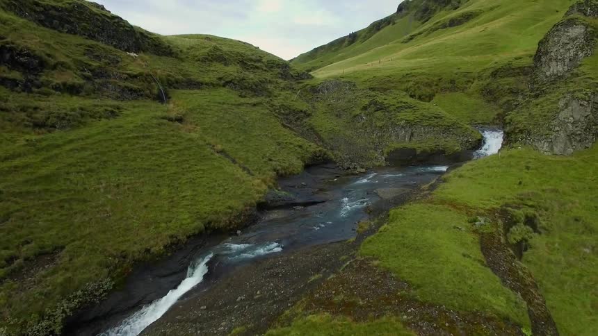 A small waterfall leading to a shallow river