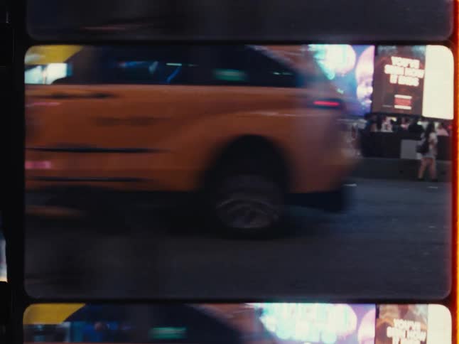 Vintage film-style footage showcases the bustling nightlife of Times Square with iconic yellow taxis, bright billboards, and hurried crowds