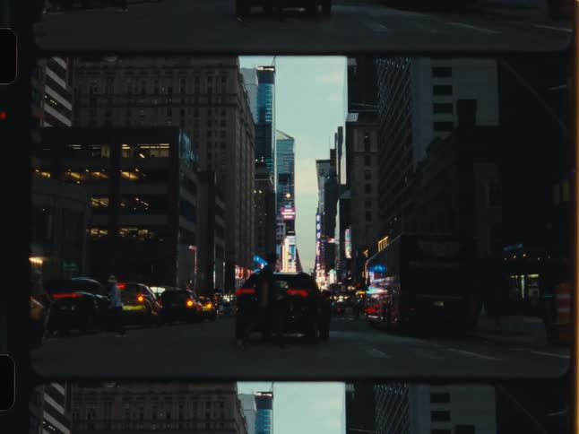 An artistic film strip view of a bustling New York City street with traffic and yellow cabs at dusk