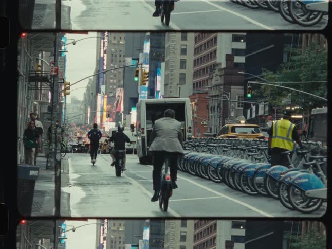Split-screen film view of commuters on a rainy New York City street and a close-up of a pedestrian signal countdown