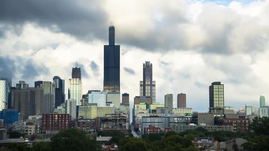A dramatic timelapse shows clouds rolling across the iconic Chicago skyline, with the Willis Tower at its center, as the sky transitions from overcast to partly sunny