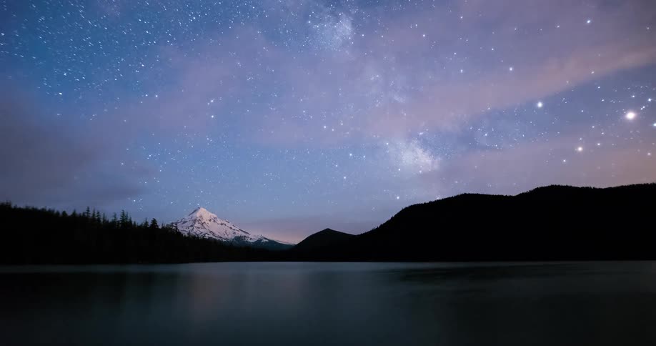 A breathtaking timelapse shows the Milky Way galaxy moving across the starry night sky over a serene mountain lake
