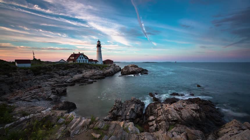 A stunning sunset time-lapse of the iconic Portland Head Lighthouse in Maine, as waves crash along the rocky coast