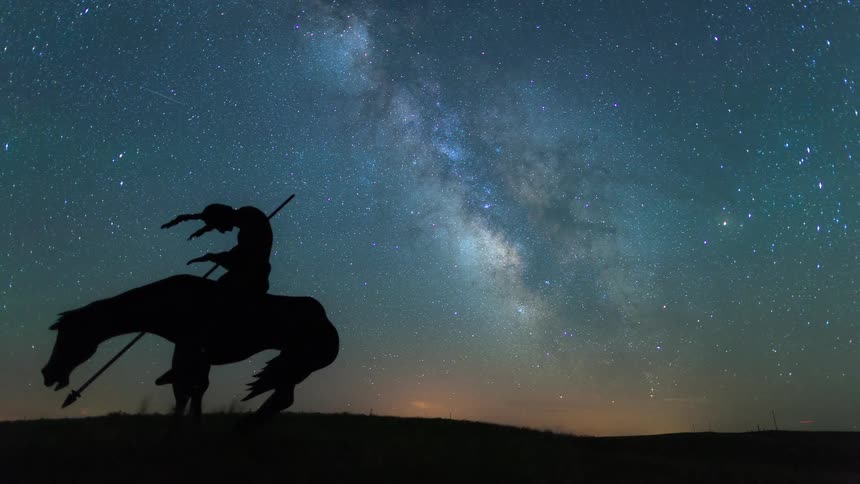 A stunning timelapse of the Milky Way galaxy rising behind the silhouette of a Native American warrior on horseback