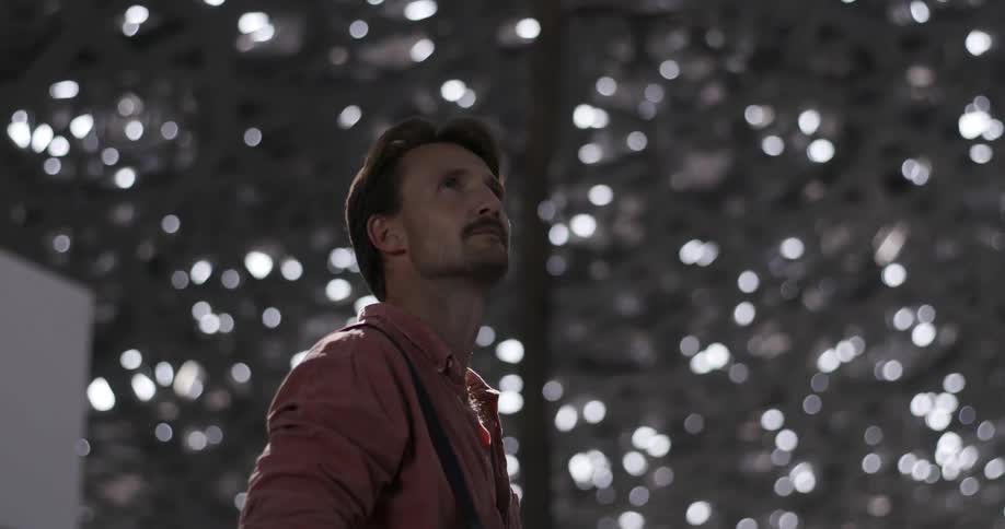 Man looking around under a structure