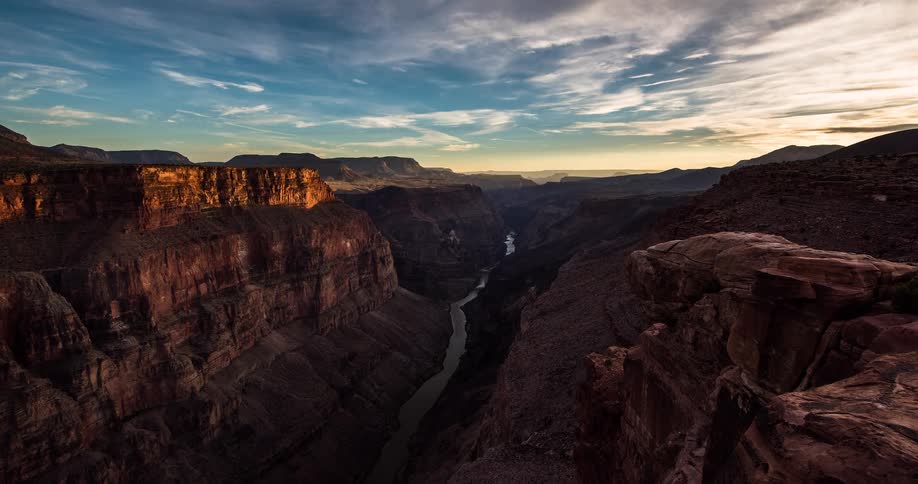 Epic timelapse of a golden hour sunset transitioning to twilight over the majestic Grand Canyon and the Colorado River