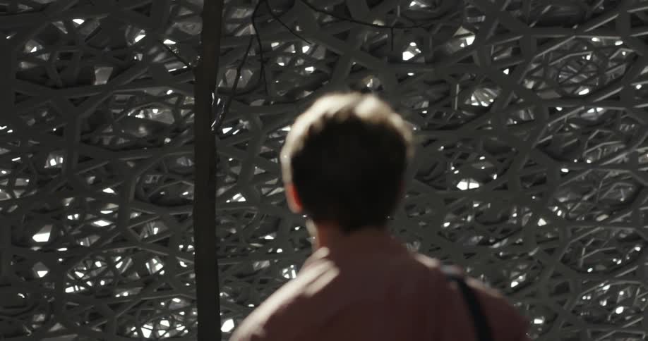 Man looking around under a structure