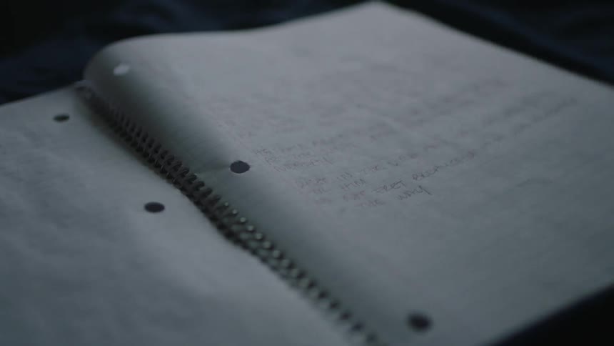 Notebook with words written on it flaps in the wind