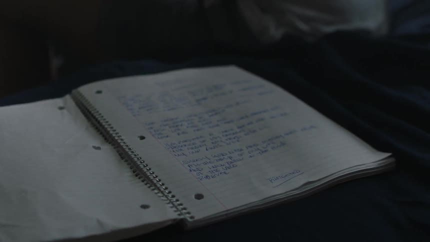 Notebook with words written on it flaps in the wind