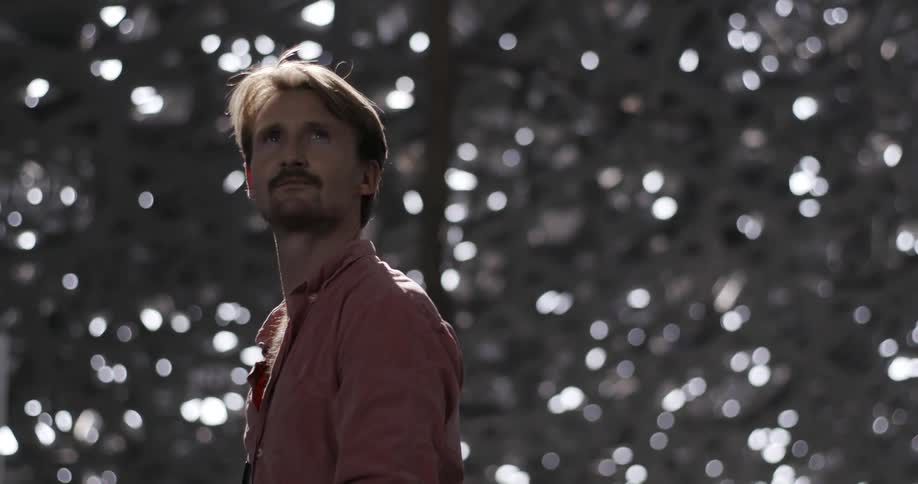 A man looks around at the trees