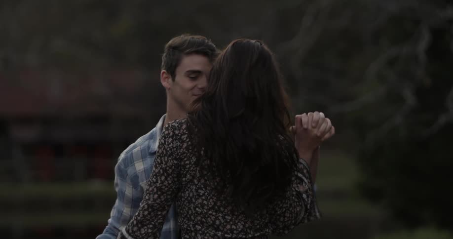 A man and woman dance outside