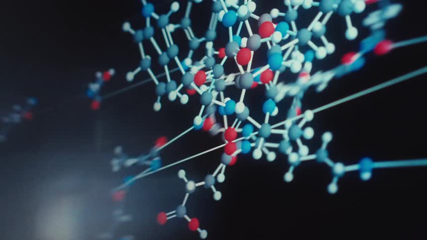 Close up of a futuristic digital interface showing scientific data and the animation of complex molecules bonding together