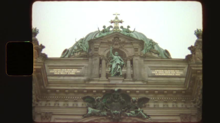 Authentic vintage footage captures a slow zoom-out of the detailed facade and dome of the Berlin Cathedral