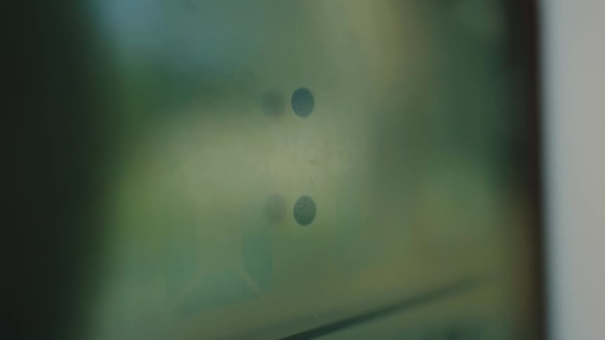 An extreme close-up shot of a digital alarm clock screen flashing the time 6:08 in the early morning