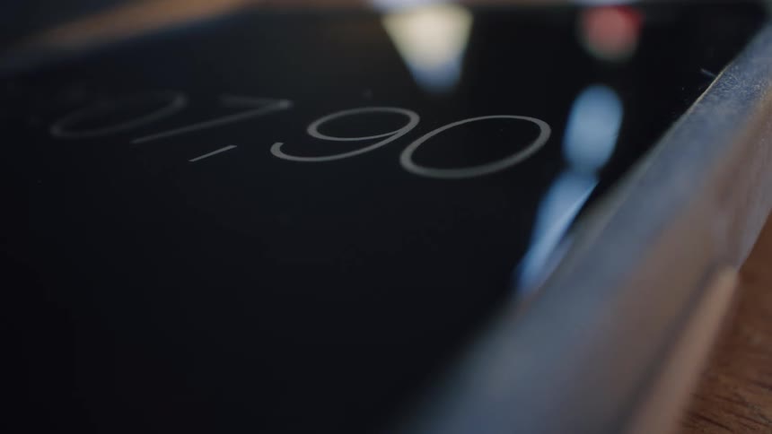 A close-up view of a digital stopwatch on a smartphone screen rapidly counting seconds and milliseconds