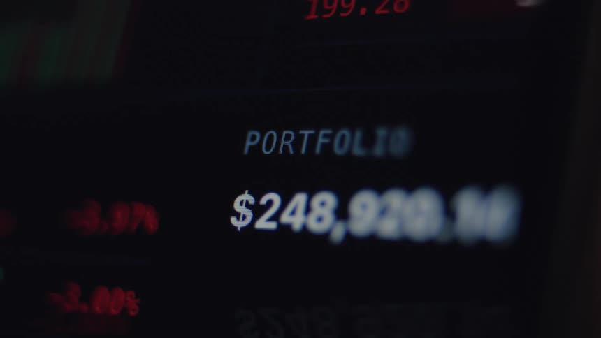 Close-up of a digital stock market screen displaying a portfolio's value with fluctuating red and green numbers